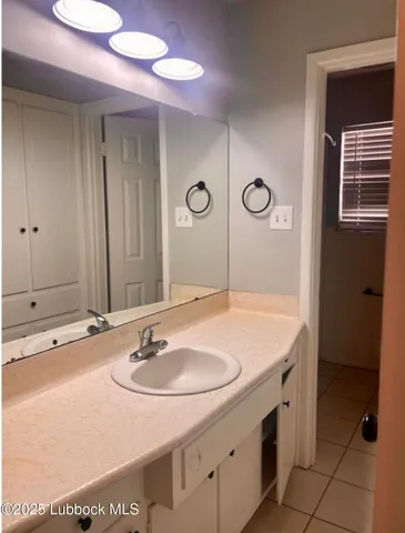 a bathroom with a sink vanity and a mirror