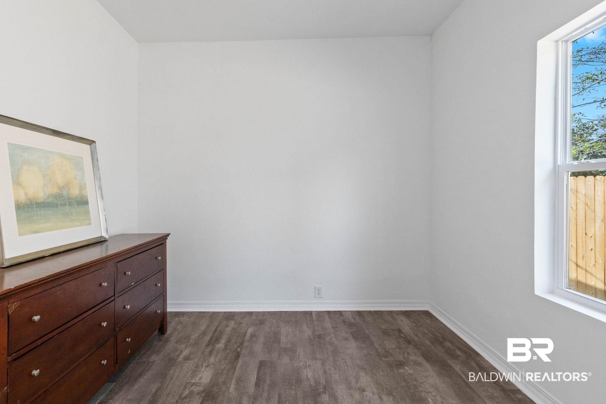128 Bush Avenue Mobile, AL 36604 - Photo 26 of 40 Unfurnished bedroom featuring dark wood finished floors and baseboards