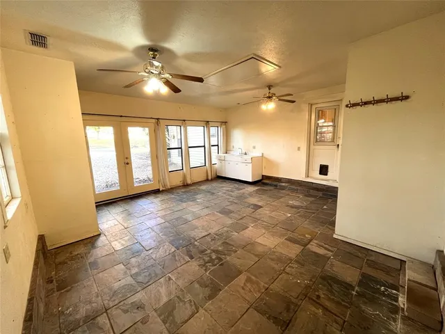 a living room with furniture a chandelier and a piano