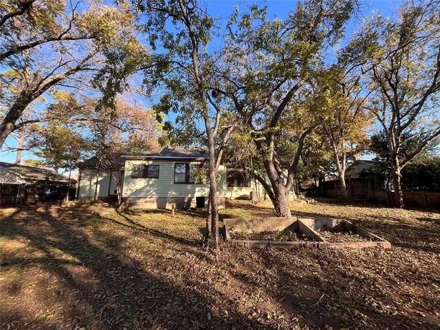 a view of a yard with trees