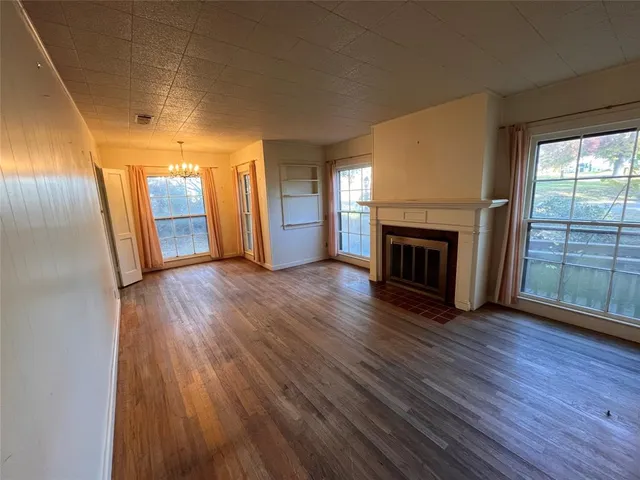 a kitchen with granite countertop a stove a sink and a refrigerator