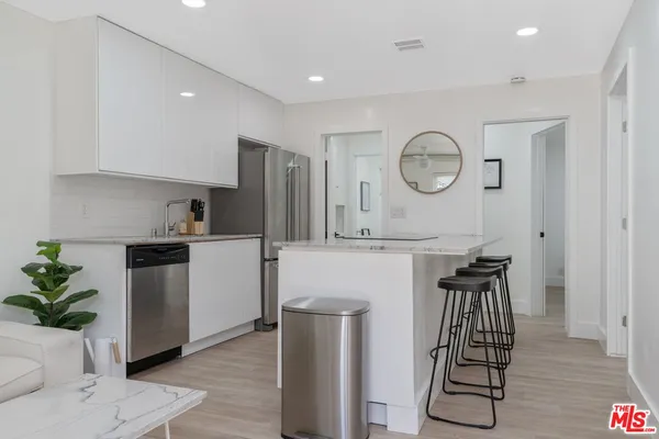 a kitchen with table and chairs