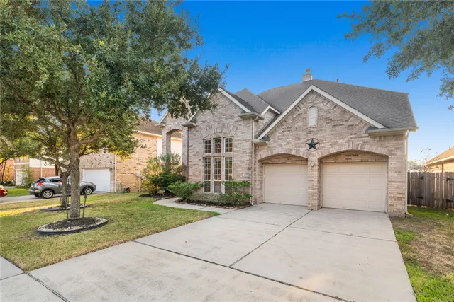 a view of house with garden space and trees