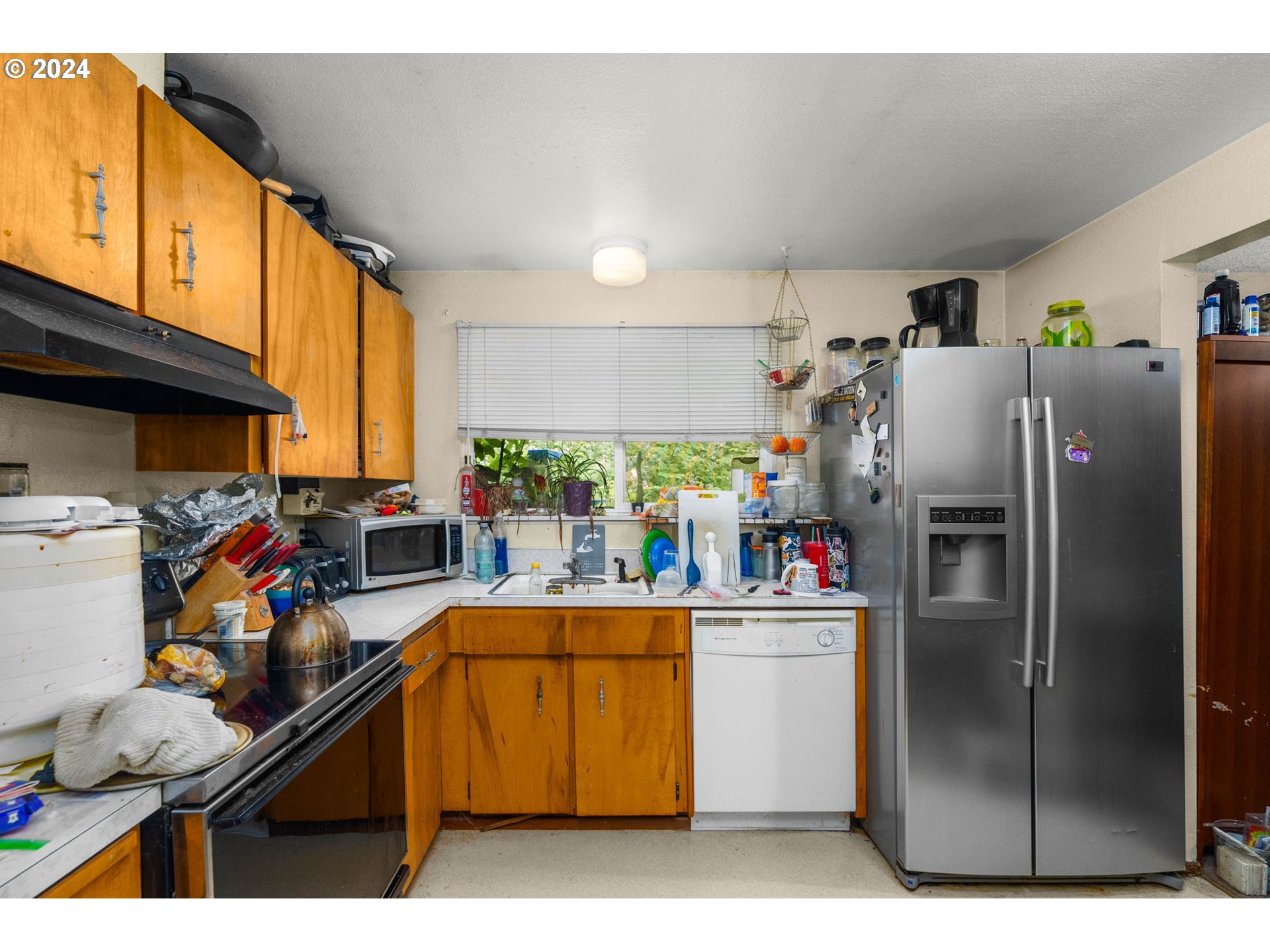 3033 Southeast Condor Avenue Gresham, OR 97080 - Photo 4 of 14 a kitchen with stainless steel appliances granite countertop a refrigerator and a stove top oven
