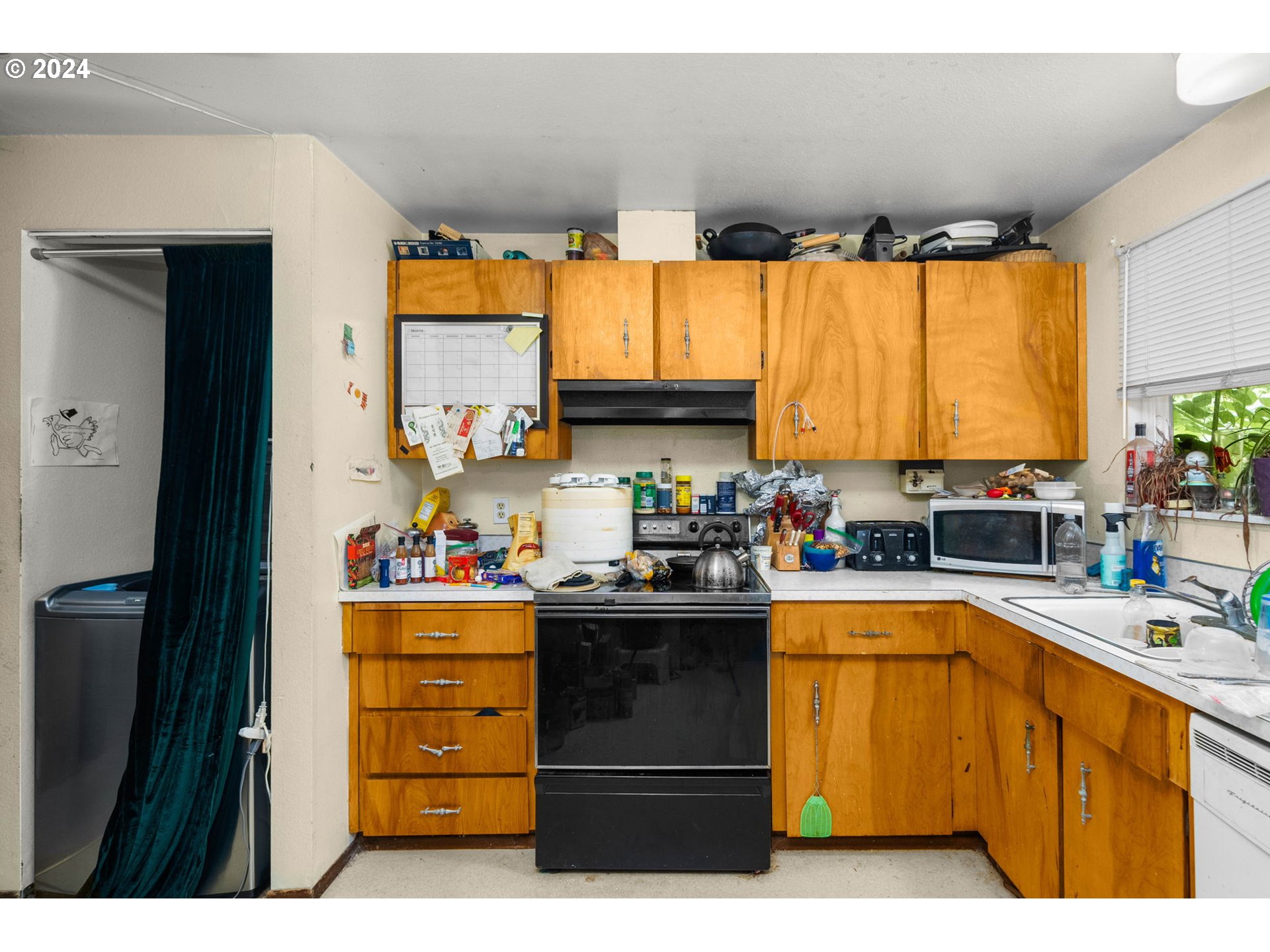 3033 Southeast Condor Avenue Gresham, OR 97080 - Photo 5 of 14 a kitchen with a sink stove and cabinets