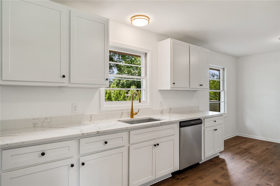 300 Vandiver Road Anderson, SC 29621 - Photo 11 of 30 A well-appointed kitchen showcasing elegant white cabinetry and durable wood flooring.