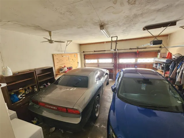 a view of a backyard with table and chairs potted plants