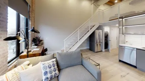 a living room with furniture and stairs