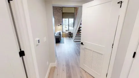 a view of a hallway view with wooden floor and staircase
