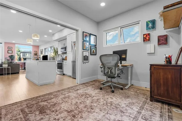 a view of a workspace with furniture and a window