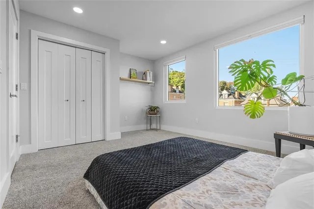 a bedroom with a bed and a potted plant