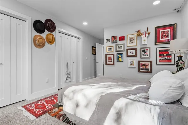 a bathroom with a granite countertop toilet sink and mirror