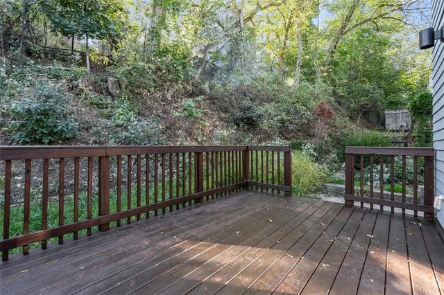 a view of a wooden door with a bench in front of a house