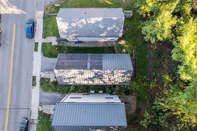 an aerial view of multiple houses with yard