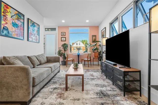 a living room with furniture a rug and a flat screen tv