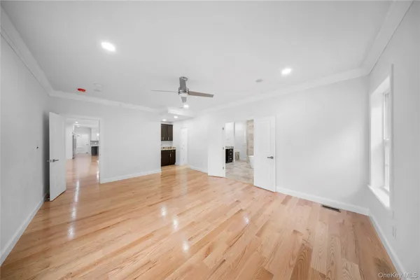 a view of empty room with wooden floor