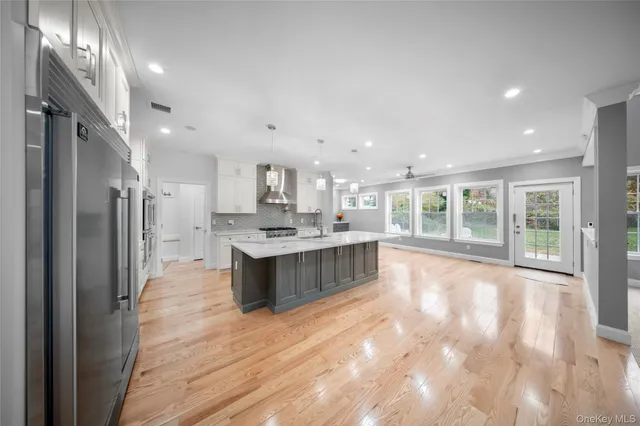 a large room with a large window and stainless steel appliances