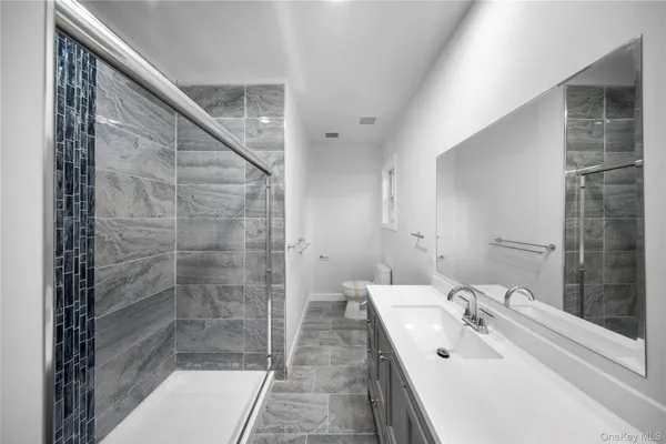 a bathroom with a sink and shower