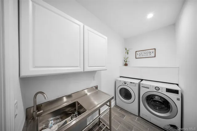 a utility room with sink dryer and washer