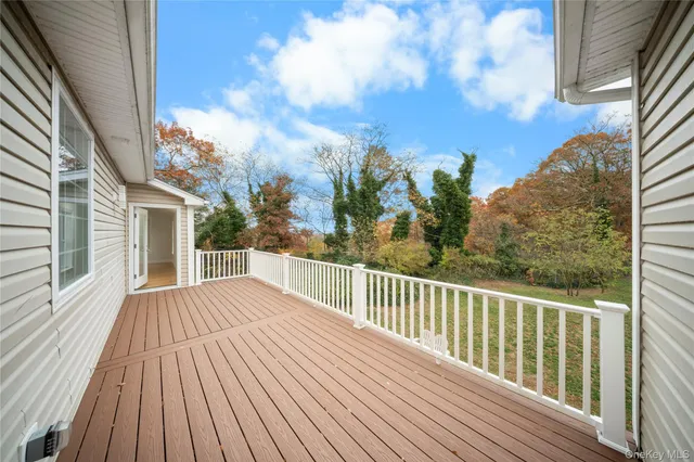 a view of a balcony with wooden floor and fence
