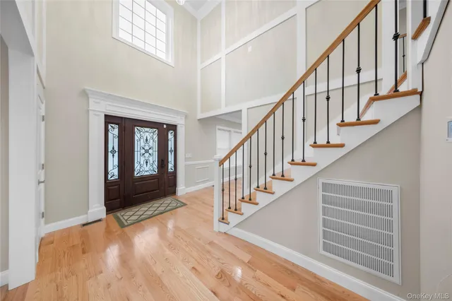 a view of entryway and hall with wooden floor
