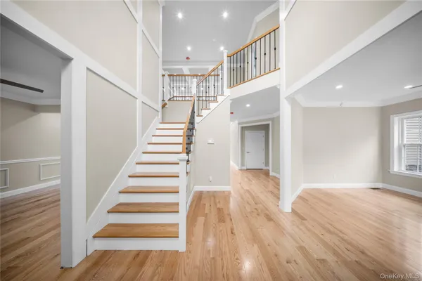 a view of entryway and hall with wooden floor