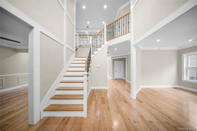 a view of entryway and hall with wooden floor