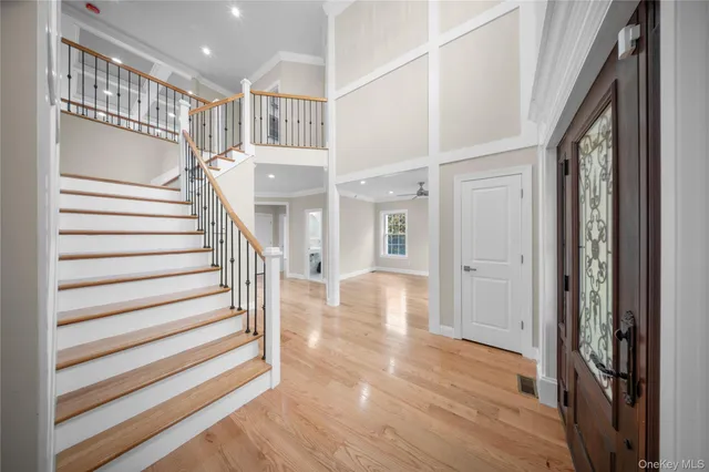 a view of entryway and hall with wooden floor