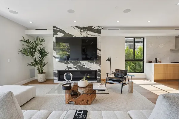 a living room with furniture a projector and a large window