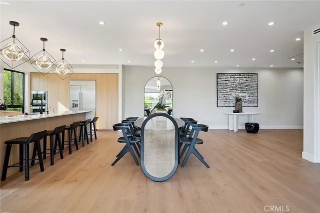 a view of an empty room with stairs and wooden floor