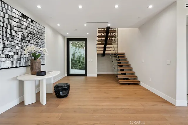 a view of a hallway with wooden floor