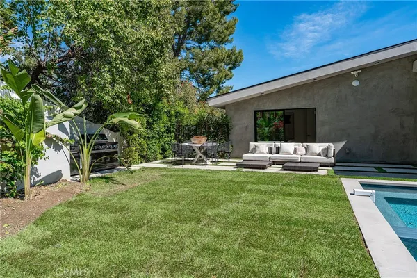 a view of swimming pool with outdoor seating and yard