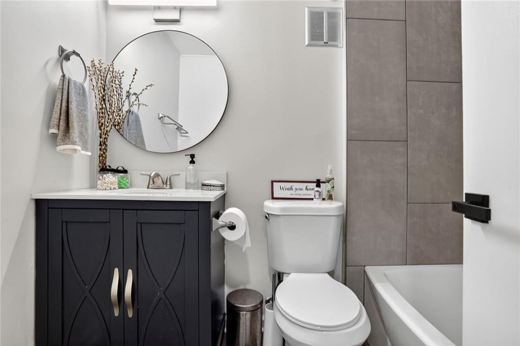 3306 Northcrest Road, Unit A Atlanta, GA 30340 - Photo 13 of 22 a bathroom with a granite countertop toilet sink and mirror