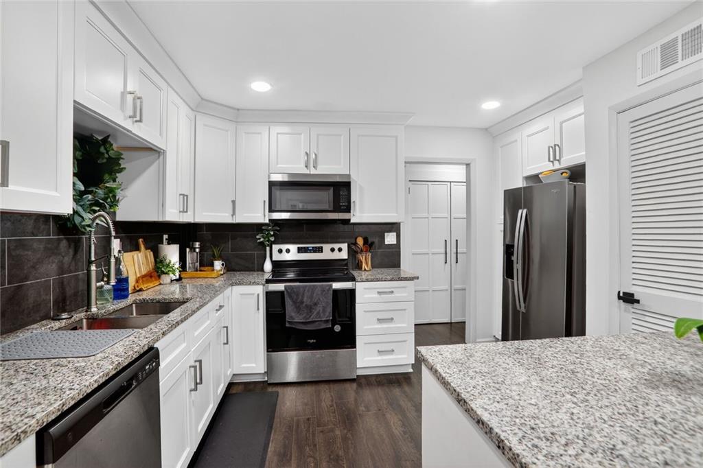 3306 Northcrest Road, Unit A Atlanta, GA 30340 - Photo 8 of 22 a kitchen with stainless steel appliances granite countertop a refrigerator a stove and a sink
