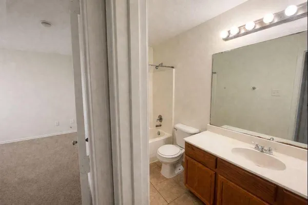 a bathroom with a double vanity sink toilet and shower