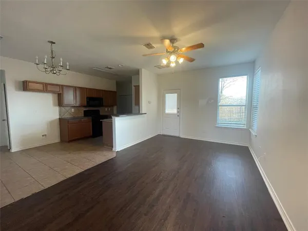 a view of a kitchen with a dishwasher cabinets and wooden floor