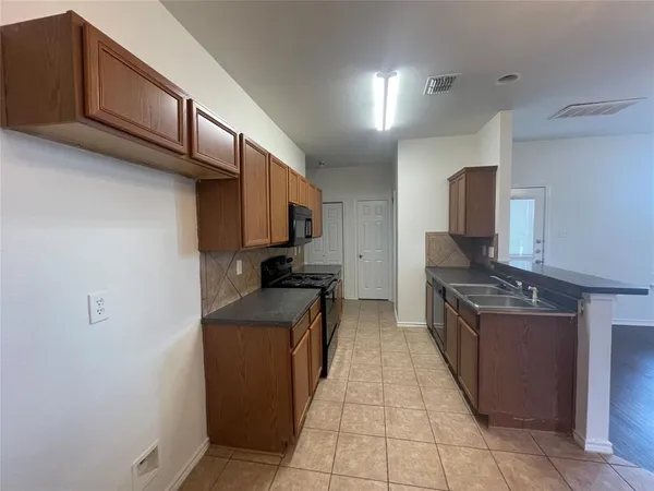 a kitchen with stainless steel appliances granite countertop a stove and a refrigerator