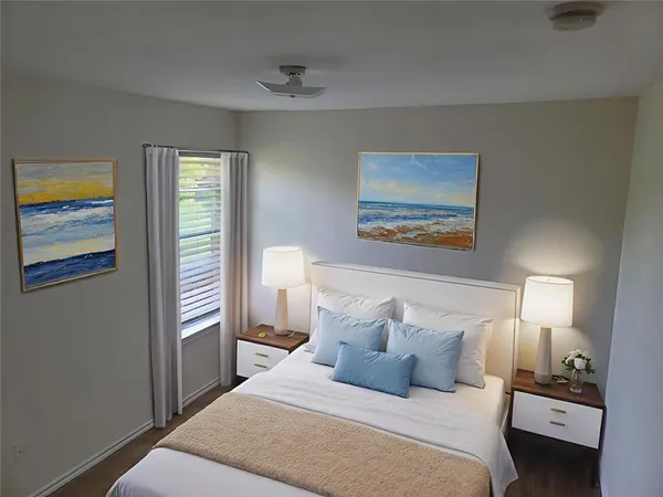 a bedroom with a bed and a lamp