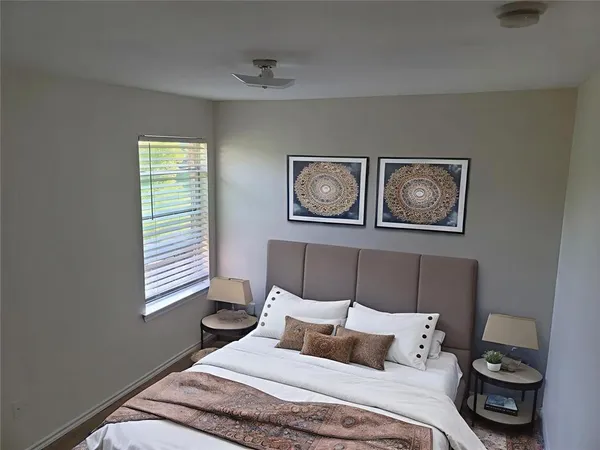 a bedroom with a bed and a window