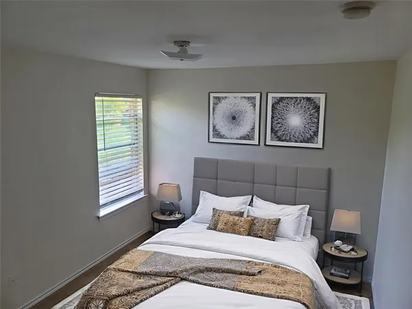 a bedroom with a bed and a window