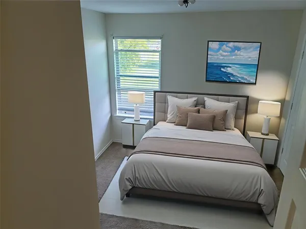 a bedroom with a bed and window