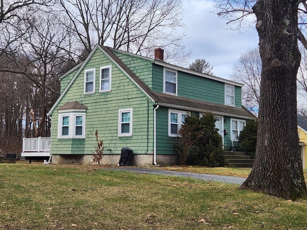 a front view of house with yard and green space
