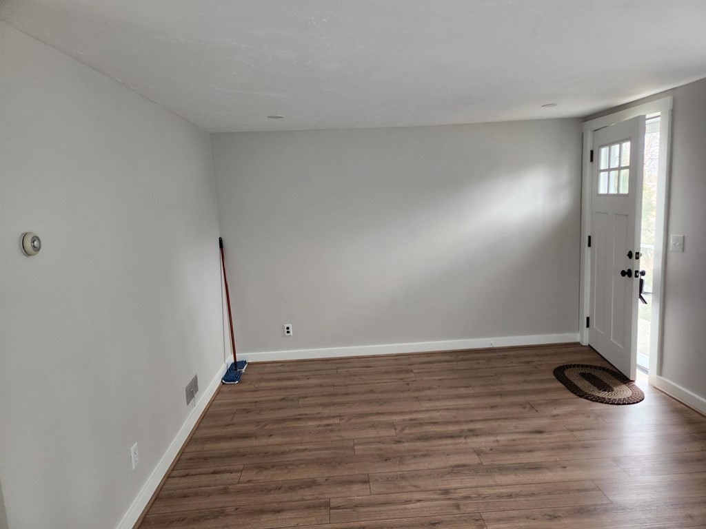 5 Ray Street, Unit 5 Hopkinton, MA 01748 - Photo 12 of 15 a view of an empty room with wooden floor and a window