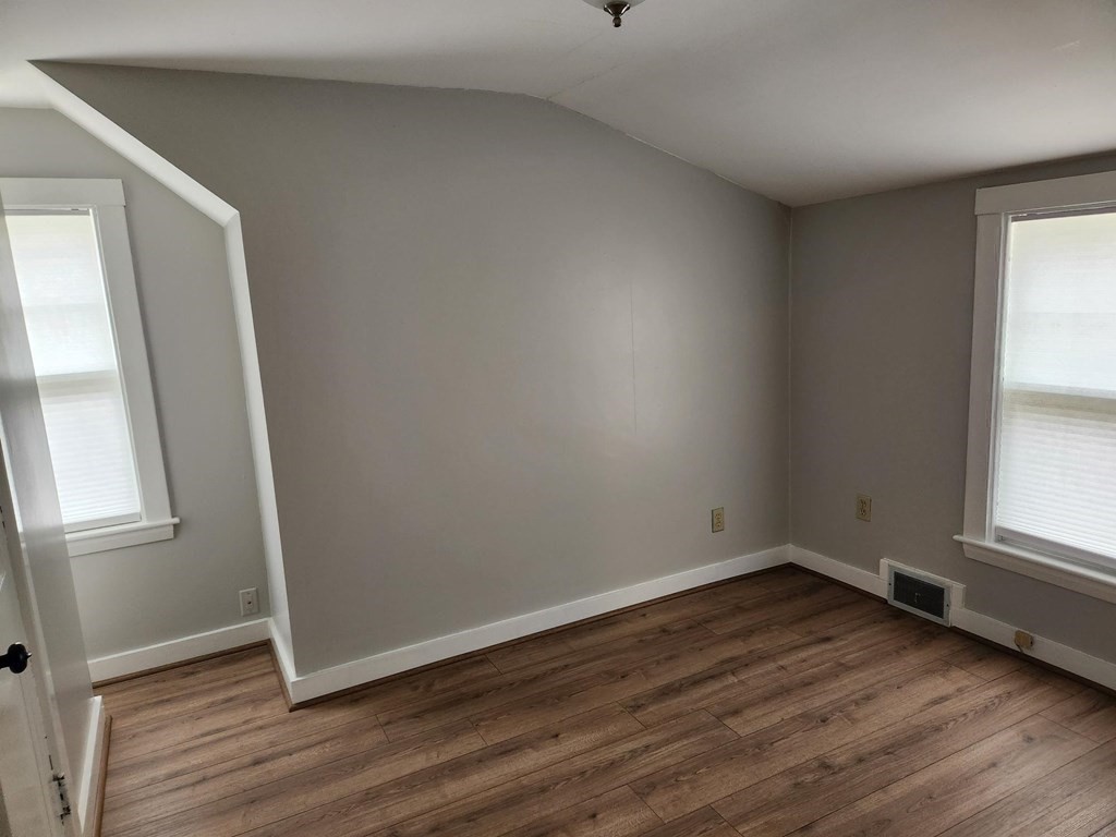 5 Ray Street, Unit 5 Hopkinton, MA 01748 - Photo 13 of 15 an empty room with wooden floor and windows