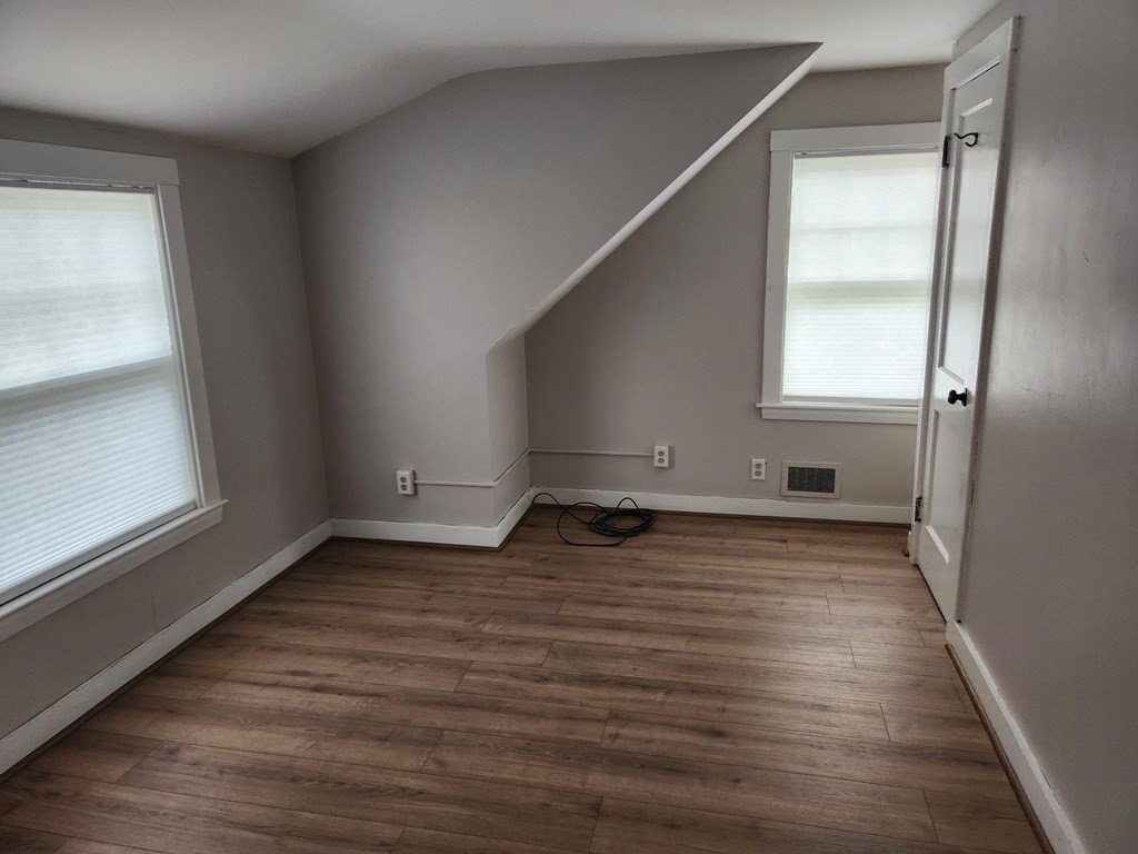 5 Ray Street, Unit 5 Hopkinton, MA 01748 - Photo 14 of 15 a view of empty room with wooden floor and fan