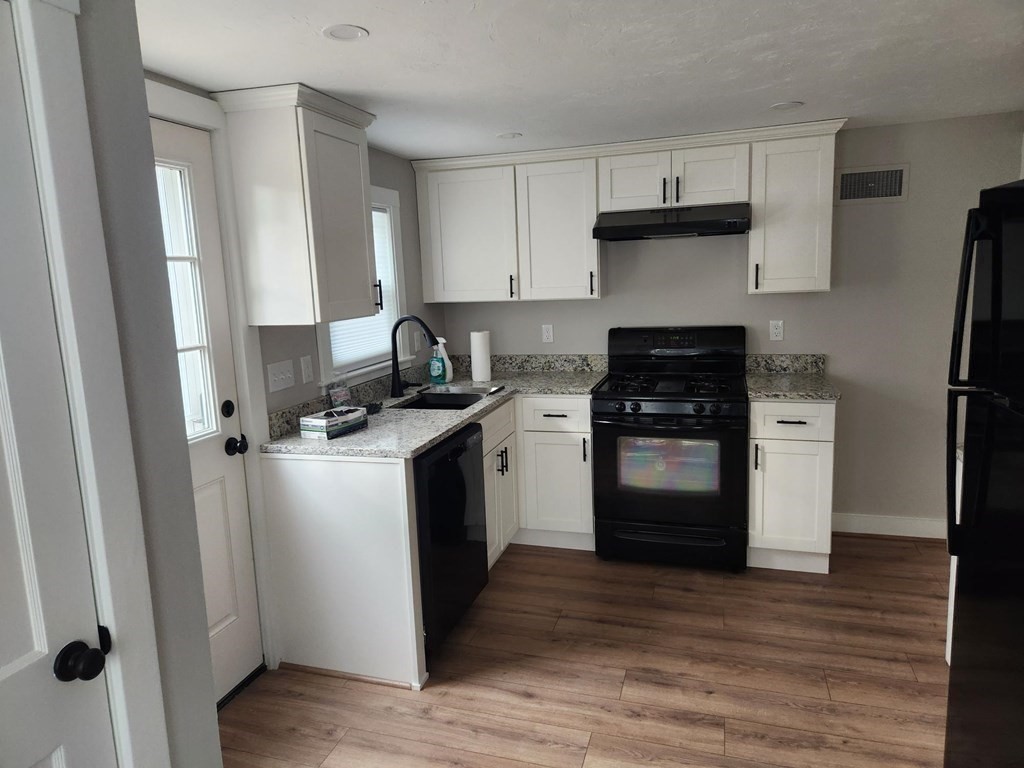 5 Ray Street, Unit 5 Hopkinton, MA 01748 - Photo 6 of 15 a kitchen with a sink stove and refrigerator