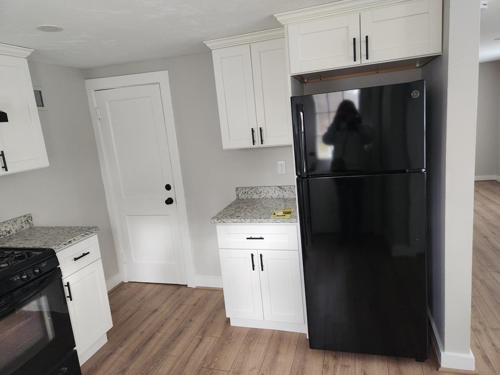 5 Ray Street, Unit 5 Hopkinton, MA 01748 - Photo 7 of 15 a kitchen with a refrigerator and a stove top oven