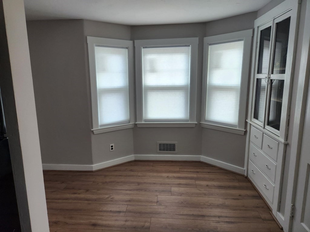 5 Ray Street, Unit 5 Hopkinton, MA 01748 - Photo 9 of 15 a view of empty room with wooden floor and fan