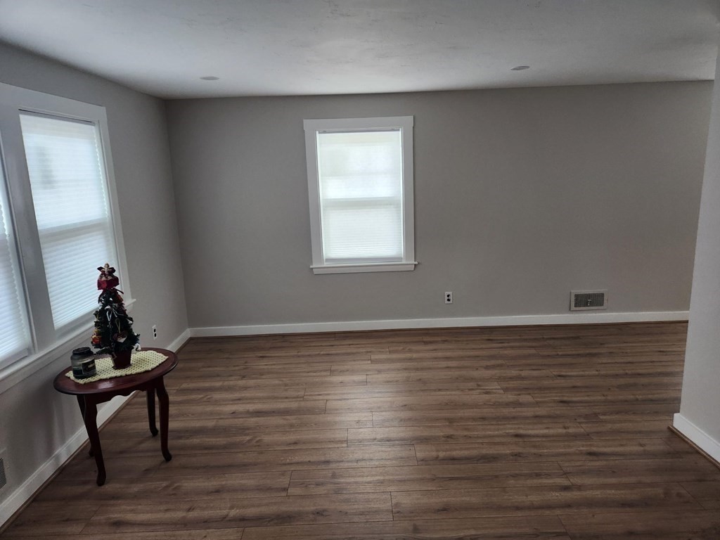 5 Ray Street, Unit 5 Hopkinton, MA 01748 - Photo 10 of 15 a room with wooden floor and a window