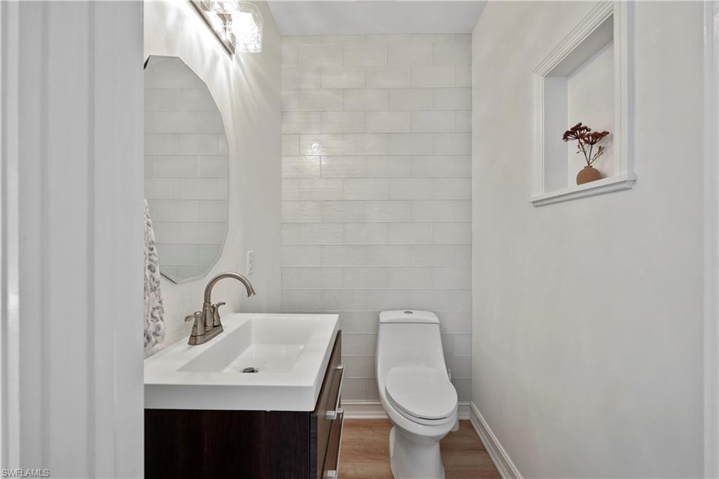 160 3rd Street North Naples, FL 34102 - Photo 20 of 48 a bathroom with a sink toilet and a mirror